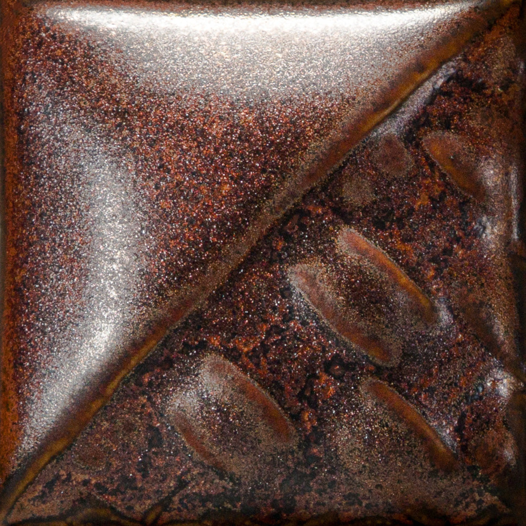Cone 6: Fires to a metallic finish, breaking green over texture. Cone 10: Shows red variation in heavy reduction. Amaranth Stoneware Canada.