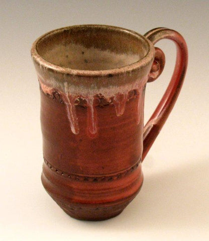 Cedar Shino glaze, variegated reddish-brown that breaks over texture, often with a lacquer-like finish. Amaranth Stoneware Canada