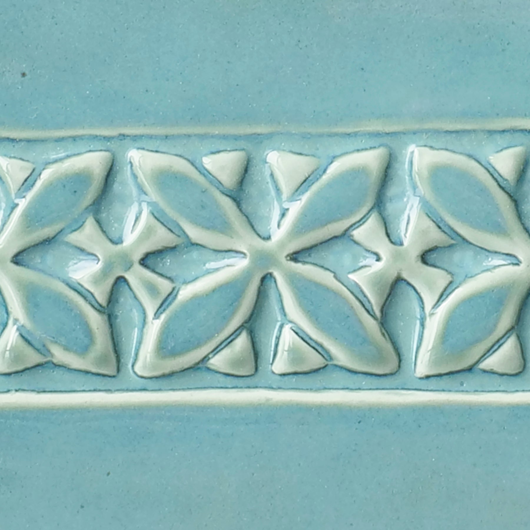 Cool Blue Lagoon glaze with milky green breaking to light blue over texture, creating tidal effects. Amaranth Stoneware Canada.