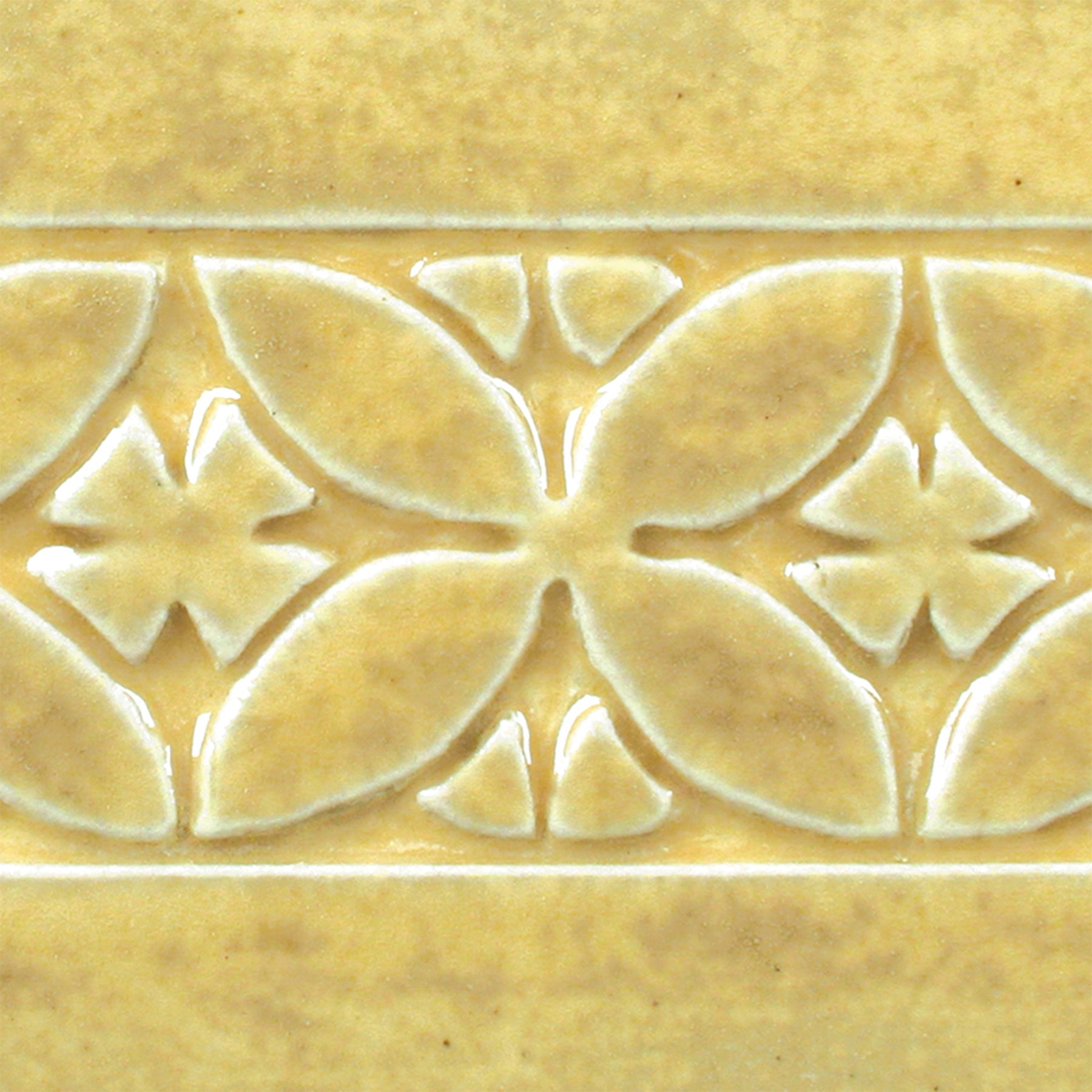 Oatmeal is a toasty, light yellow glaze that is relatively opaque and breaks clear over textured surfaces. Amaranth Stoneware Canada.