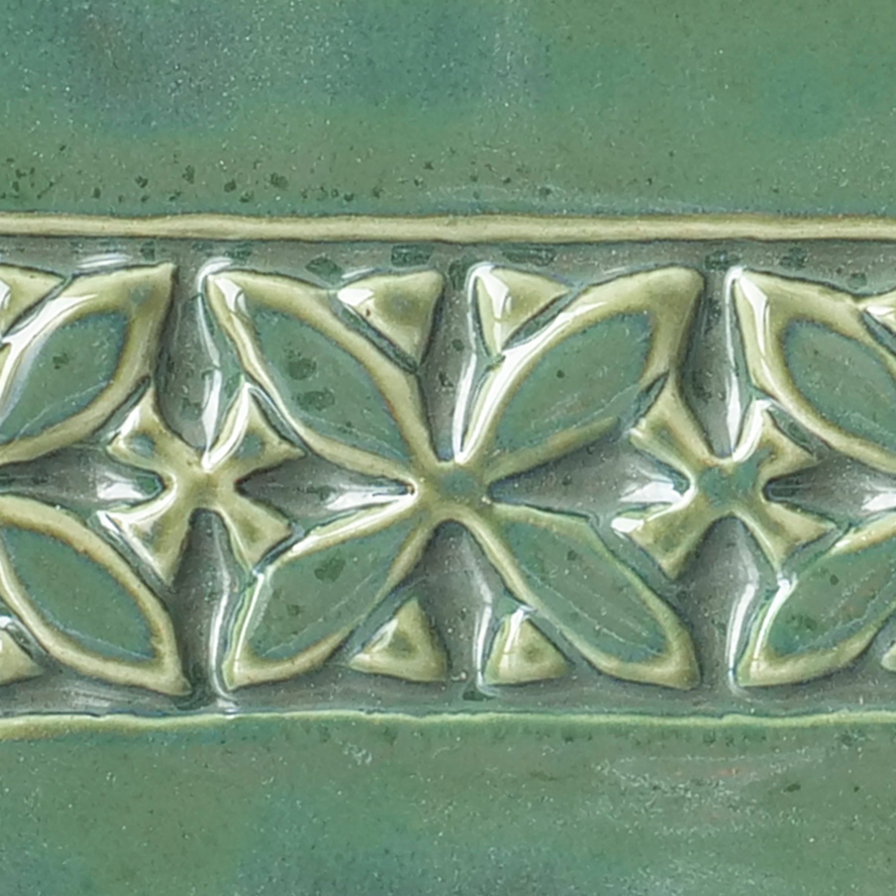 Glossy Emerald Falls glaze, breaking to mauve grey-green, with moss-like surface variations. Amaranth Stoneware Canada.