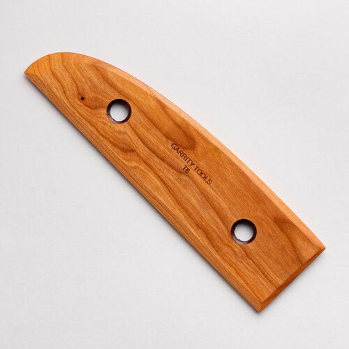 T6 tool with stable straight edges and a curve, ideal for creating solid cylinders and supporting tall walls. 8.5" x 2.5", made of cherry wood. Handmade in St. Louis, MO. Amaranth Stoneware Canada.