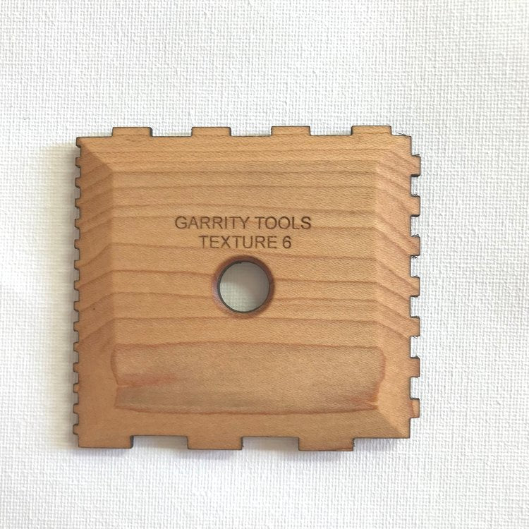 Texture 6 creates squared ridges with four sizes of geometric patterns for unique textures. 3.5" x 3.25", made of maple wood. Handmade in St. Louis, MO. Amaranth Stoneware Canada.