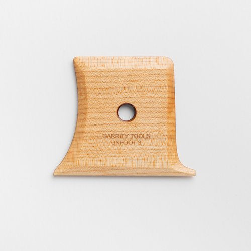 Unfoot 3 lifts your vessel with a soft curve and flat edge for easy undercutting while preserving wall shape. 4.25" x 3.25", made of maple wood. Handmade in St. Louis, MO. Amaranth Stoneware Canada.