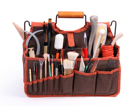 The Xiem Art Bag is a durable, breathable solution for ceramic tool storage. Features 17 pockets, 16 holsters, 2 large compartments, secure straps, and a reinforced bottom. Holds up to 25 lbs. Measures 16