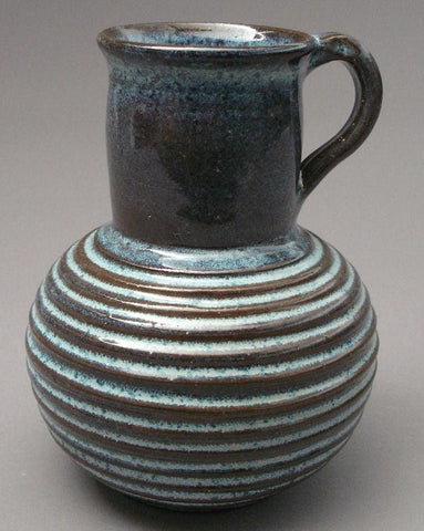 A brilliant pearlescent blue glaze that varies from translucent where thin to mottled where thick. It's possibly our runniest glaze. Amaranth Stoneware Canada.