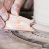 Big Foot Fetish Rib, a versatile wooden tool with beveled edges for controlled finishing on rims and galleys. Ideal for shaping and creating a foot for trimming. Amaranth Stoneware Canada.