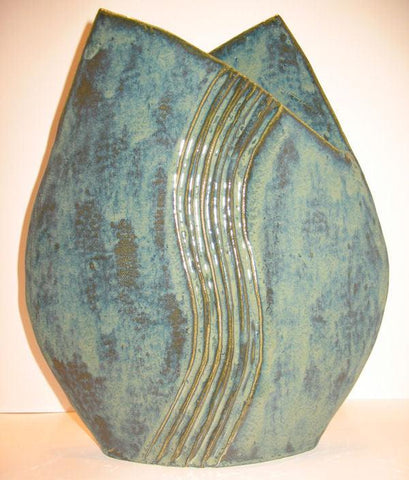 A deep, mottled green glaze that creates a rich variegated surface, especially when paired with the Archie's Base. Amaranth Stoneware Canada.