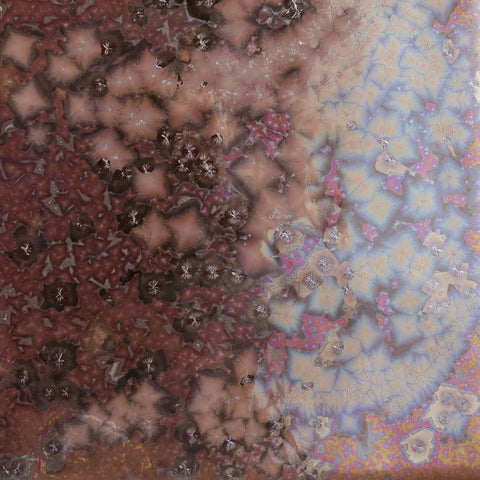 Solar Rainbow is a highly fluid, dark gloss glaze with iridescent rainbow crystals. Breaks translucent. Amaranth Stoneware Canada.