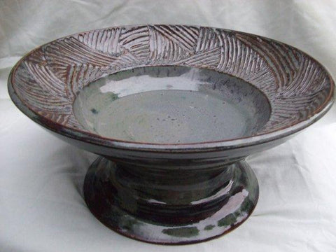 A mottled greyish blue glaze that offers surface variety like Pam's Green but with a softer color. Amaranth Stoneware Canada.