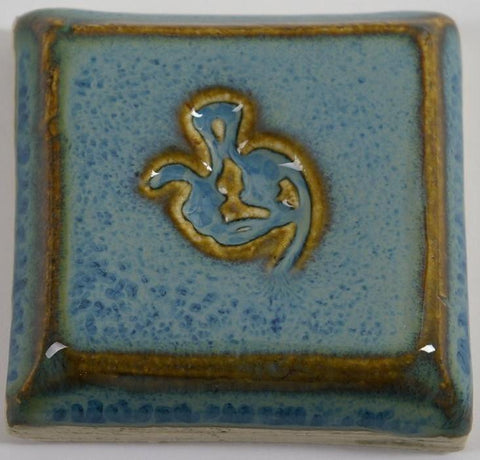 Arctic Blue glaze, a glossy, opaque light blue on white clay, and green-blue on red clay, breaks brown over texture. Amaranth Stoneware Canada. 