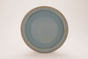 Arctic Blue glaze, a glossy, opaque light blue on white clay, and green-blue on red clay, breaks brown over texture. Amaranth Stoneware Canada.