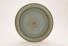 Arctic Blue glaze, a glossy, opaque light blue on white clay, and green-blue on red clay, breaks brown over texture. Amaranth Stoneware Canada.