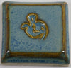 Arctic Blue glaze, a glossy, opaque light blue on white clay, and green-blue on red clay, breaks brown over texture. Amaranth Stoneware Canada. 