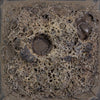 Cone 6: Charcoal-colored, high-texture glaze creating a rough, cratered surface; texture slightly flattens at Cone 10 with no color change. Amaranth Stoneware Canada.