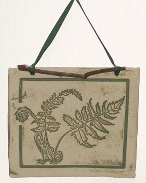 Handcrafted 4x4-inch stoneware Botanicals featuring seasonal plants and creatures. Finished with dogwood and ribbon. Weatherproof. Handcrafted in Kingston, Ontario at Amaranth Stoneware.