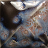 Cone 6: Semi-transparent charcoal gloss glaze with a three-tone crystal of white, orange, and blue; showcases more blue hues with melted crystals at Cone 10. Amaranth Stoneware Canada.