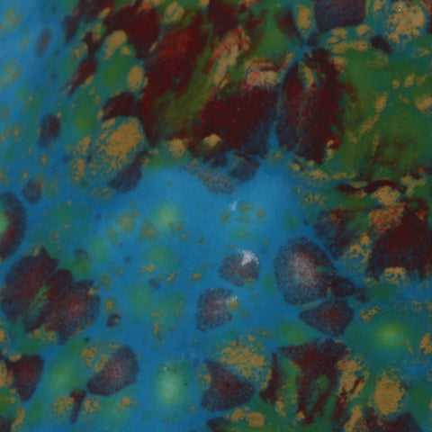 Monet’s Pond translucent bright blue with red, green, and yellow crystals at Cone 06.
At Cone 6: Base glaze remains, crystals melt with enhanced mobility. Surface issues may occur. Amaranth Stoneware Canada.







