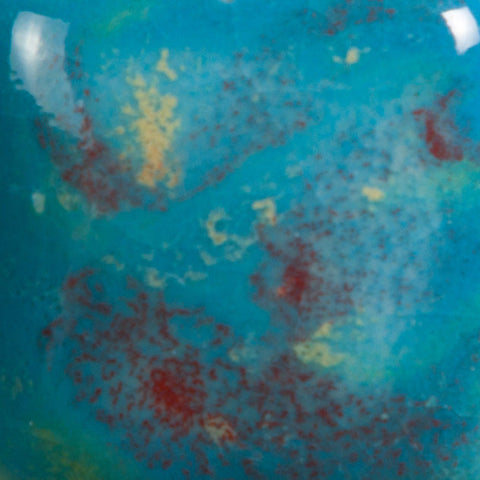 Monet’s Pond translucent bright blue with red, green, and yellow crystals at Cone 06.
At Cone 6: Base glaze remains, crystals melt with enhanced mobility. Surface issues may occur. Amaranth Stoneware Canada.






