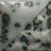 Moonscape gray to white variegation with black crystals at Cone 6; more variegation and crystals with extra coats.
At Cone 10: Gray turns blue, crystals melt. Amaranth Stoneware Canada.