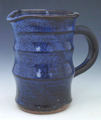A black base that transforms into a deep, variegated cobalt blue when applied thick. Perfect for various ceramic creations. Amaranth Stoneware Canada.