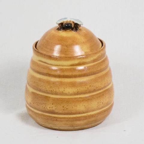 Warm yellow glaze that breaks to brown over texture. Ideal for layering with darker colors, offering a signature Shino look. Amaranth Stoneware Canada.