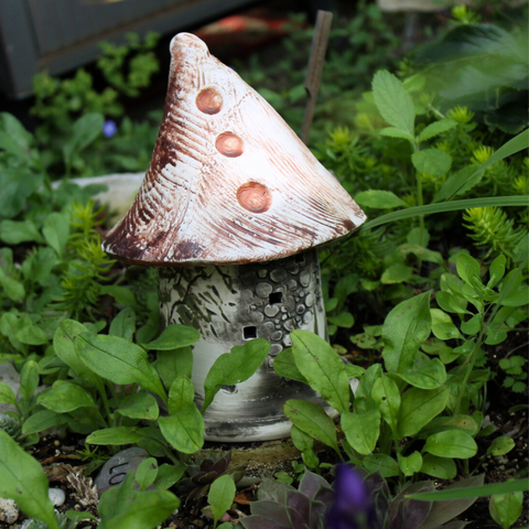 Handcrafted 7x4-inch Ladybug Castle with removable lid, perfect for creating a sanctuary for ladybugs in your garden. Weatherproof and handcrafted in Kingston, Ontario at Amaranth Stoneware.