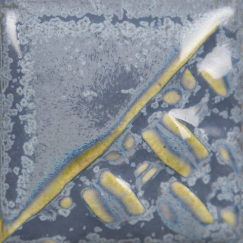 Nimbus glossy, opaque, variegated blue glaze with iridescent sheen and blue micro-crystallization at Cone 6.
At Cone 10: Brightens to variegated cyan, breaks green/brown over texture. Amaranth Stoneware Canada.