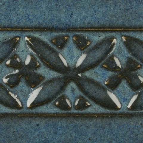 Blue Midnight is a glossy black glaze with blue highlights in thick areas, ideal for textured work and layering. Amaranth Stoneware Canada.