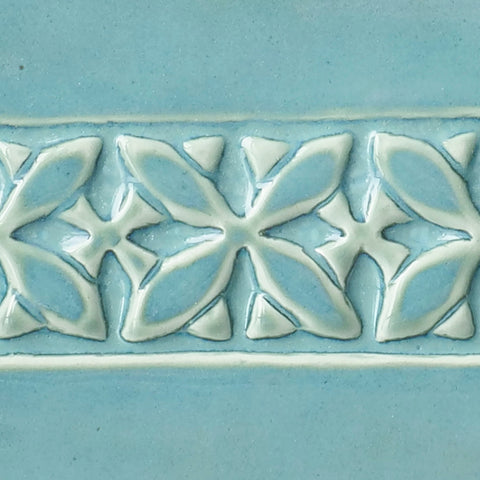 Cool Blue Lagoon glaze with milky green breaking to light blue over texture, creating tidal effects. Amaranth Stoneware Canada.