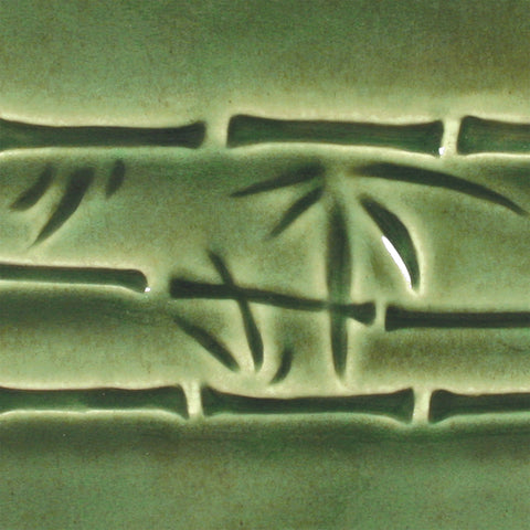 Dark green is a fluid, translucent emerald glaze that shows off textured and carved ware. Amaranth Stoneware Canada.