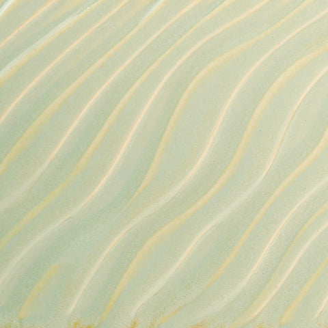 Glossy pale green Melon glaze, breaking on texture with peachy float, great for layering. Amaranth Stoneware Canada.