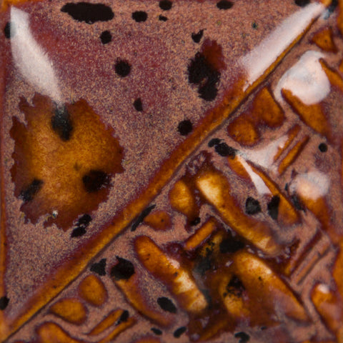 Peppered Plum glossy, opaque burgundy glaze with taupe float and black/burgundy crystals at Cone 6.
At Cone 10: Glaze darkens, crystals soften. Amaranth Stoneware Canada.