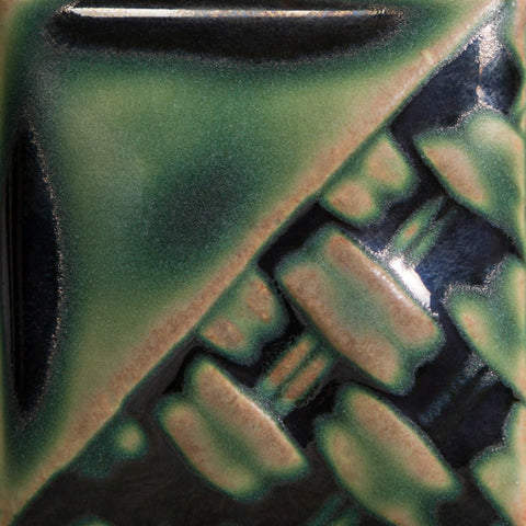 Rainforest soft matte emerald green glaze at Cone 6; pools dark and glossy, breaks light brown.
At Cone 10: Changes to light brown with green variation, increased movement. Amaranth Stoneware Canada.