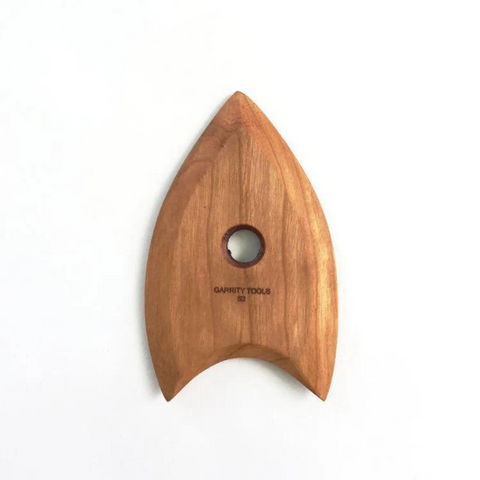 
S2 tool with a concave end, sharp tip, and curved sides for creating rounded forms, trimming, and subtle shaping. 4