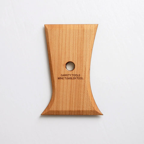 The Wine Tumbler Tool shapes perfect stemless wine glasses with two curved sides for red, white, or bubbles. 5” x 3.5”, made of maple wood. Handmade in St. Louis, MO. Amaranth Stoneware Canada.