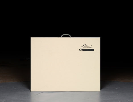 X-Board™ is a portable, durable clay board with a galvanized steel handle, non-skid rubber base, and canvas surface for easy wedging. Amaranth Stoneware Canada.